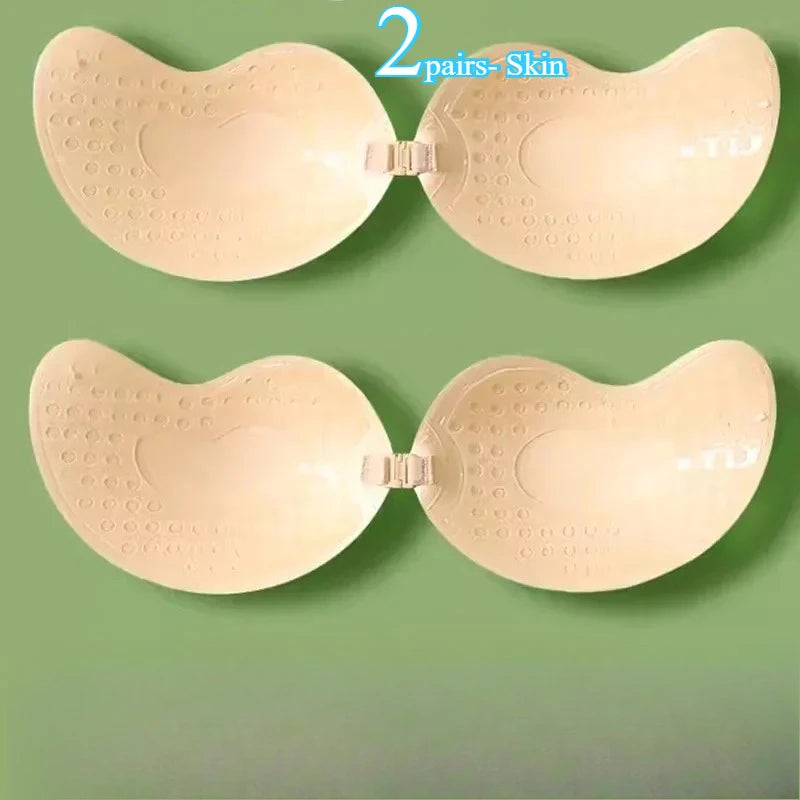 2 pairs black and skin adhesive bra held in hands